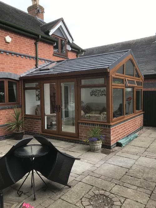 Oak-effect gable conservatory with bi-fold doors
