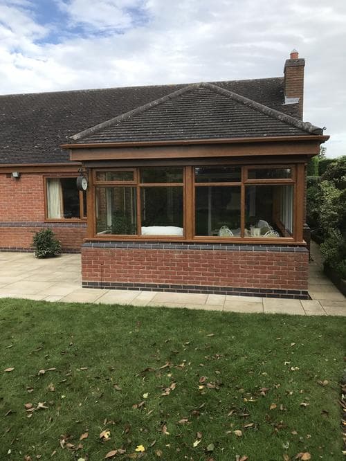 Oak-effect lean-to conservatory with casement windows