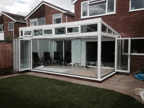 White gable garden room with bi-fold doors, open