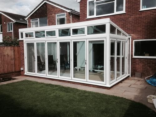 White gable garden room with bi-fold doors, exterior view