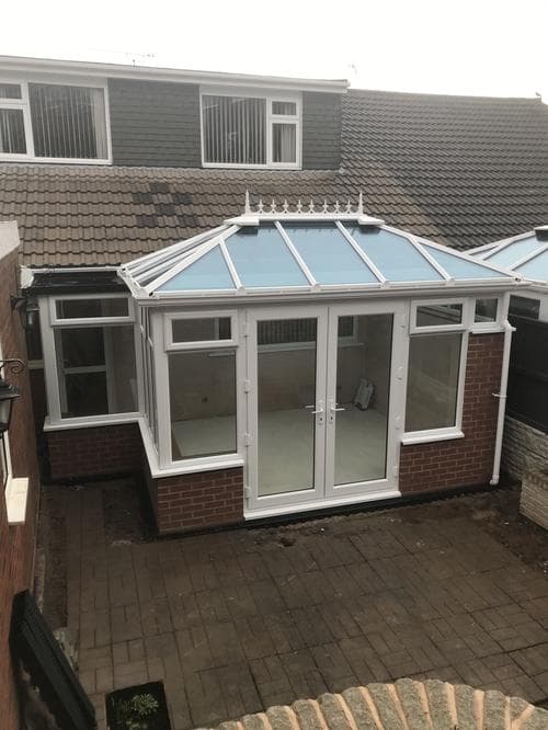 White conservatory with a tinted blue glass roof