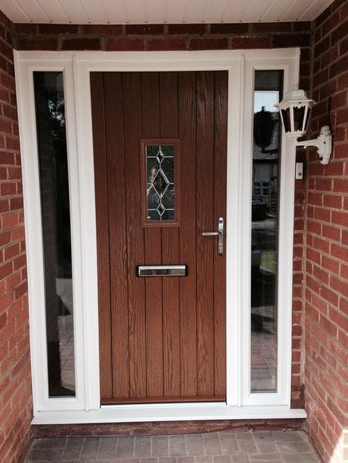 Oak composite door with diamond leaded glass in a porch