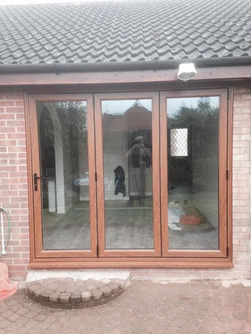 Sage green composite door with diamond bullseye glazing