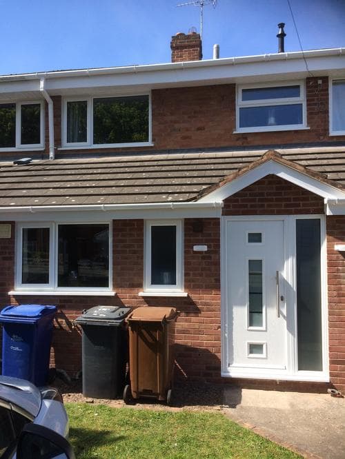 White UPVC casement windows with gable porch and composite door