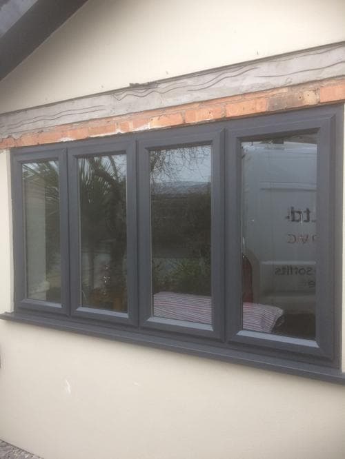 Close-up of anthracite grey four-panel casement window