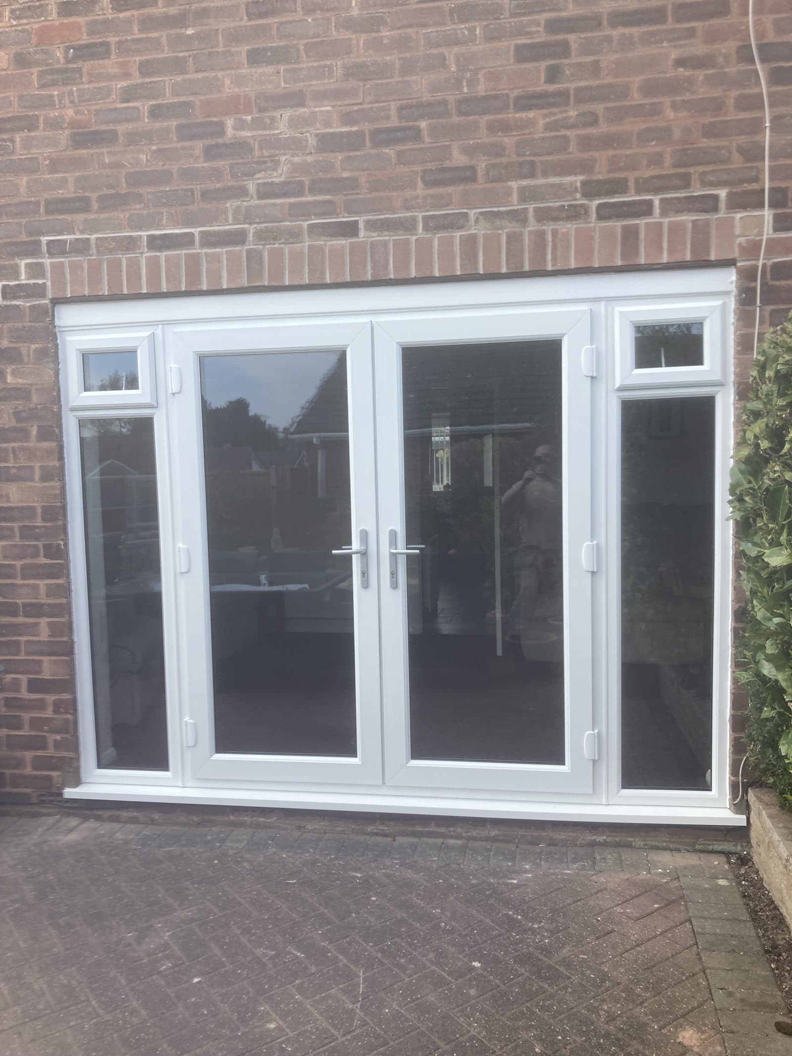 White UPVC French doors with side glazing
