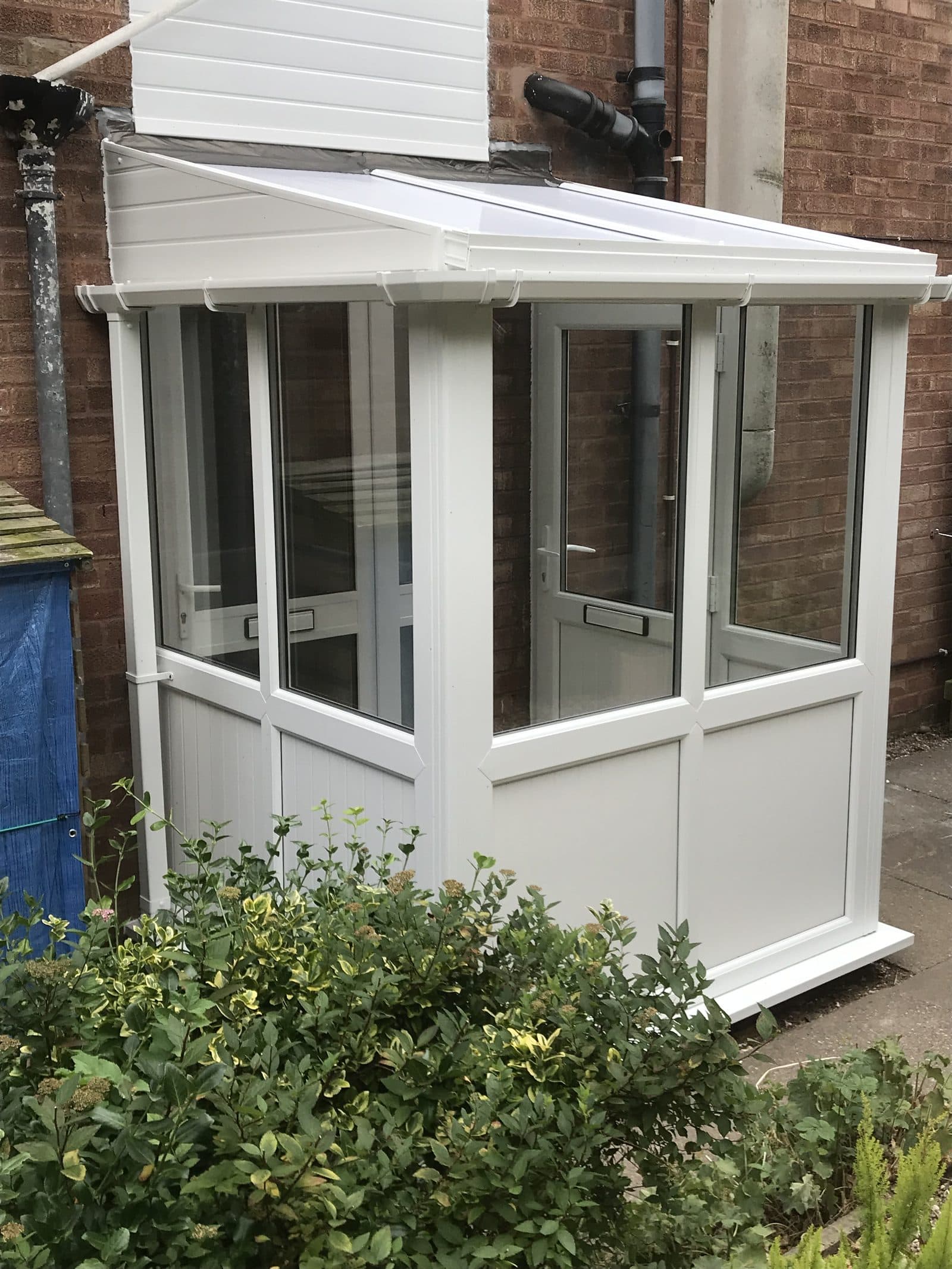 White gable-fronted porch with glazed sides and composite door